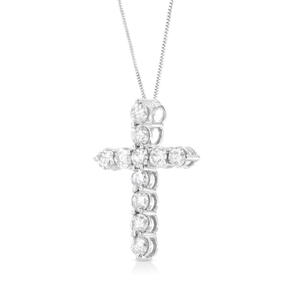 Close-up front angled view of a white metal cross-shaped necklace pendant with round white gemstones in prong settings, hanging from a white metal chain.