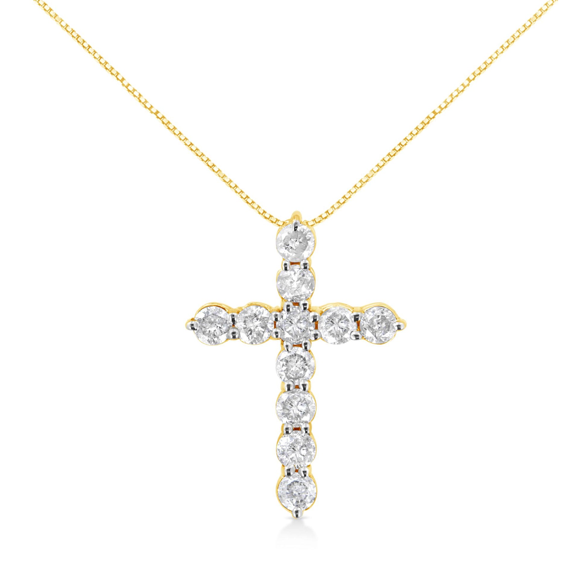 Front view of a yellow metal cross-shaped necklace pendant adorned with round white gemstones in prong settings.