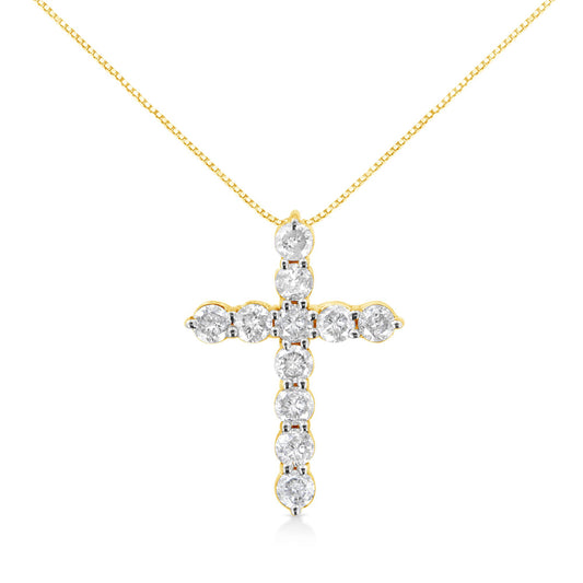 Front view of a yellow metal cross-shaped necklace pendant adorned with round white gemstones in prong settings.