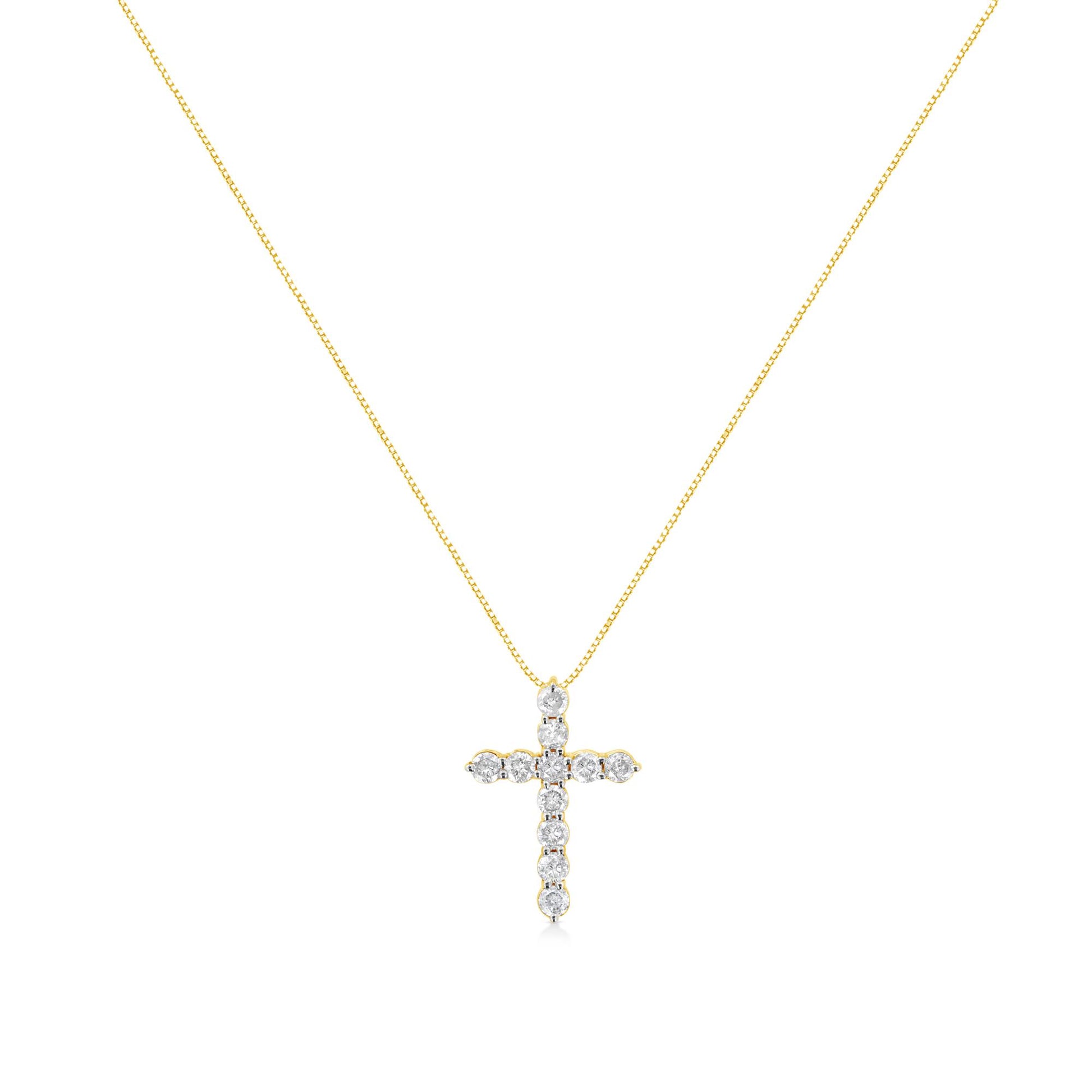 Front angle of a yellow metal necklace with a cross-shaped pendant featuring round white gemstones in prong settings.
