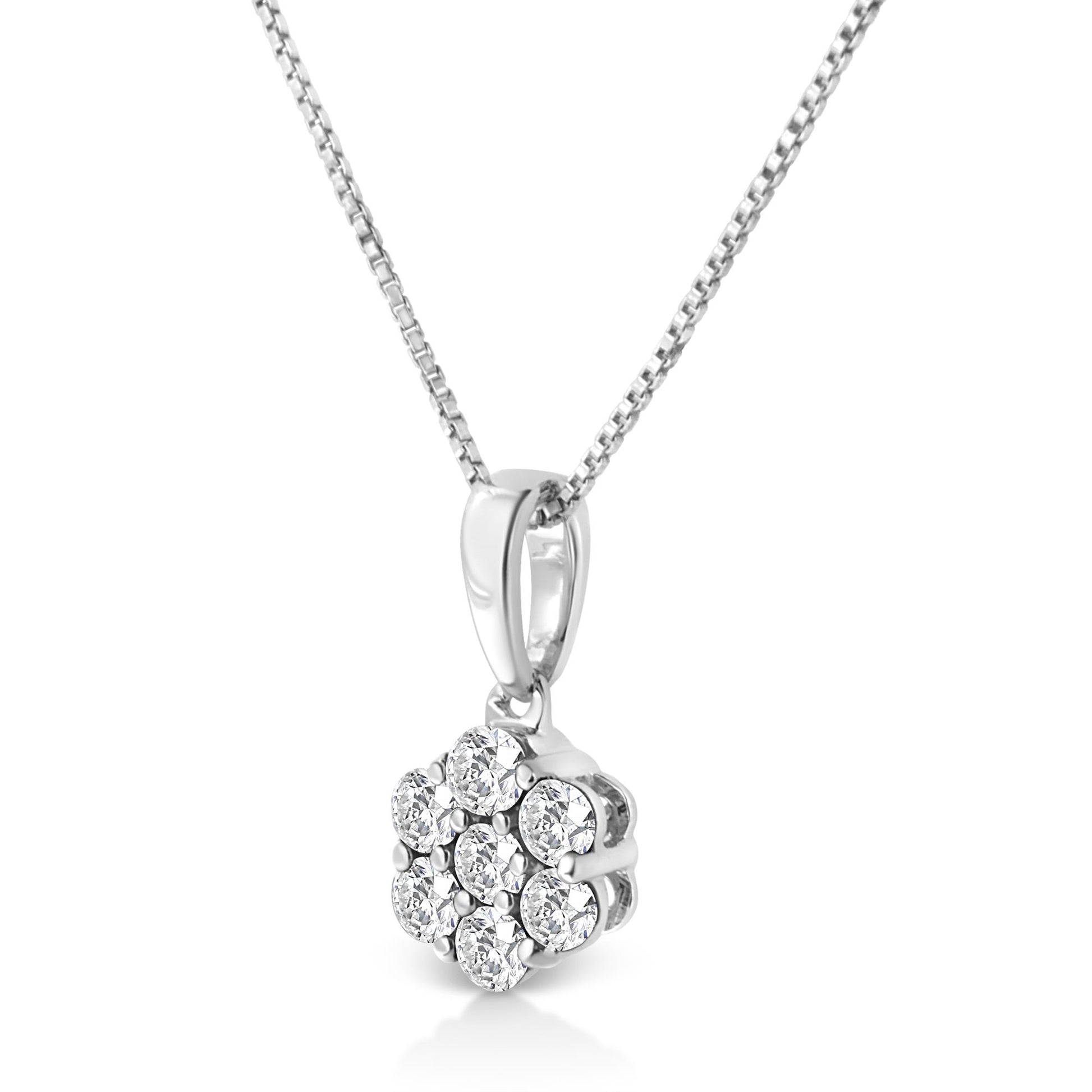 White metal necklace with a flower-shaped pendant featuring round white gemstones in prong settings, shown in a close-up angled front view.