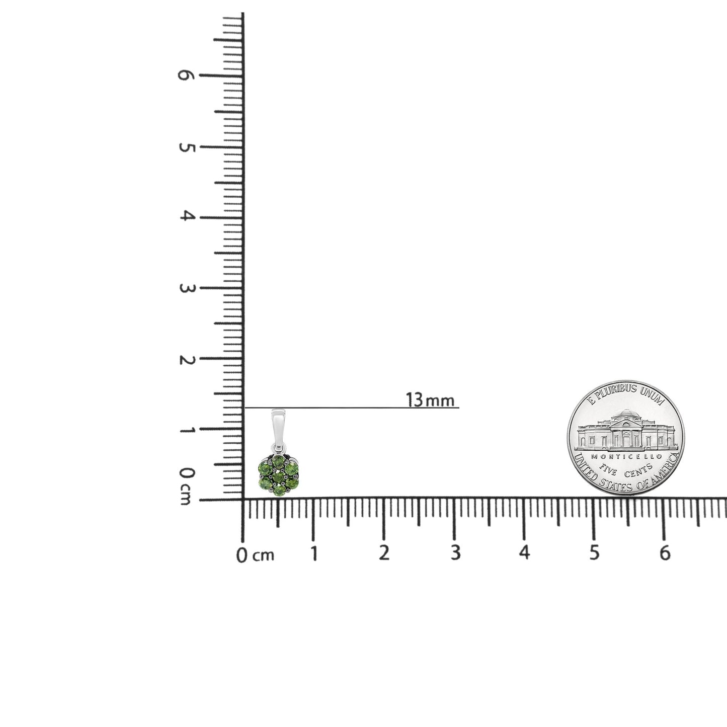 White metal necklace pendant with round prong-set green gemstones arranged in a cluster, shown on a ruler for size reference, shot from the front.