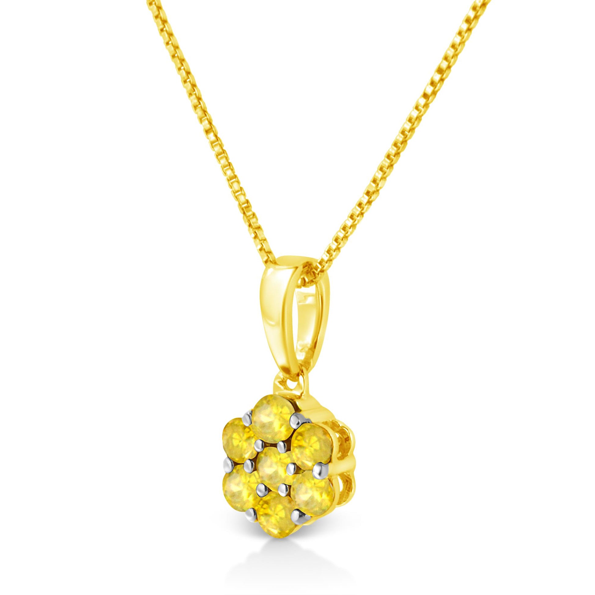 Close-up front angle of a yellow metal necklace with a pendant featuring seven round yellow gemstones in prong settings.