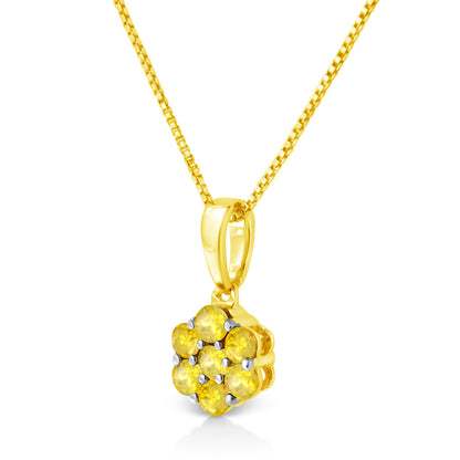 Close-up front angle of a yellow metal necklace with a pendant featuring seven round yellow gemstones in prong settings.
