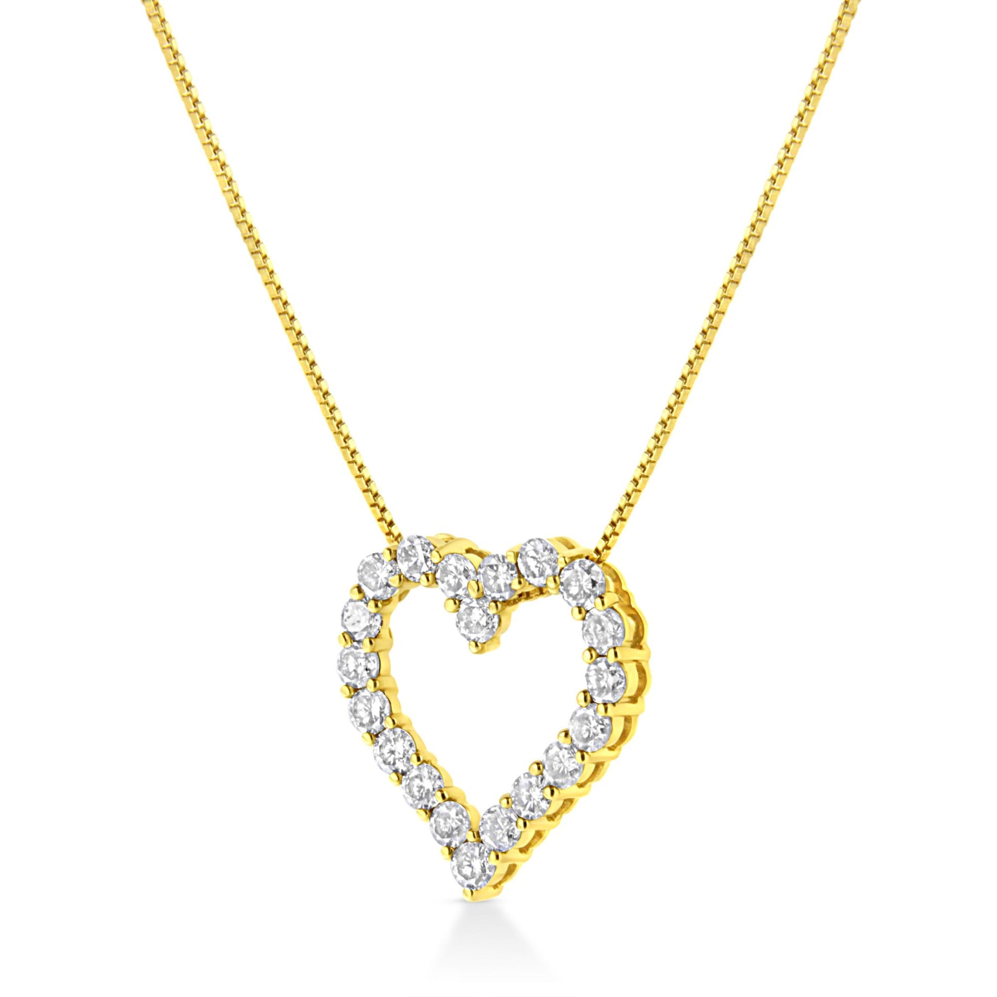 Yellow metal necklace with a heart-shaped pendant set with round white gemstones in a prong setting, shown at a front angle.