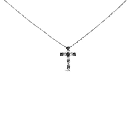 Front view of a white metal necklace with a cross-shaped pendant featuring alternating black and white round gemstones in prong settings.