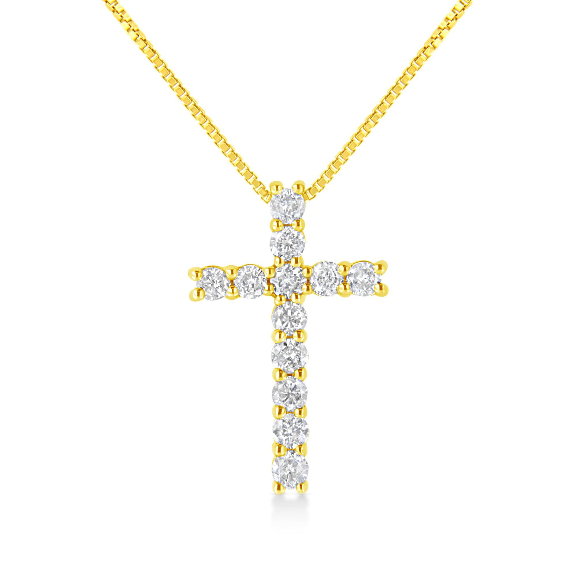 Front angle view of a yellow metal necklace with a cross-shaped pendant featuring round white gemstones in prong settings.