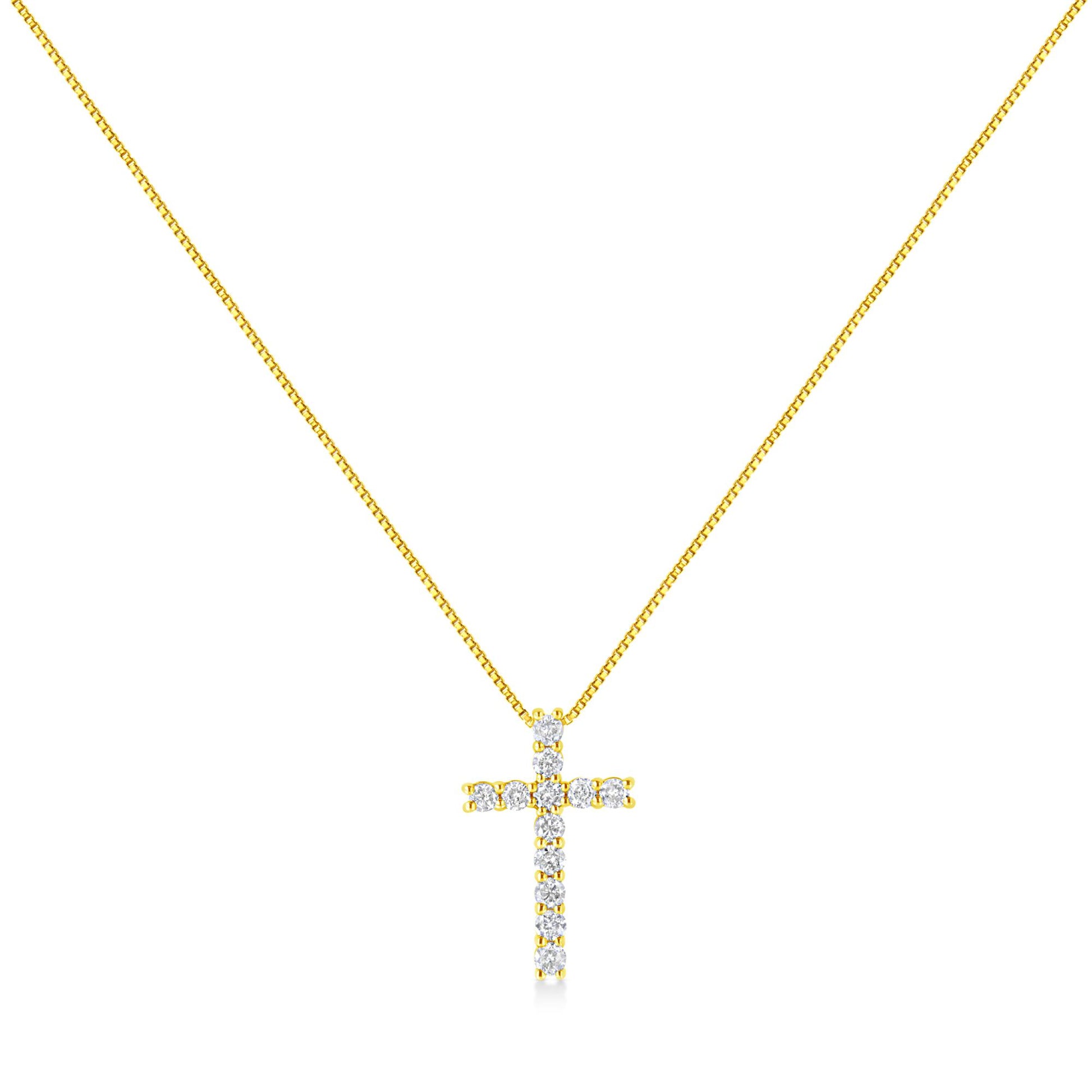 Front-facing shot of a yellow metal necklace with a cross pendant adorned with round white gemstones in prong settings.