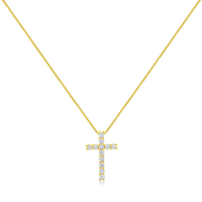 Front-facing shot of a yellow metal necklace with a cross pendant adorned with round white gemstones in prong settings.