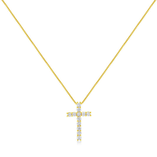 Front-facing shot of a yellow metal necklace with a cross pendant adorned with round white gemstones in prong settings.