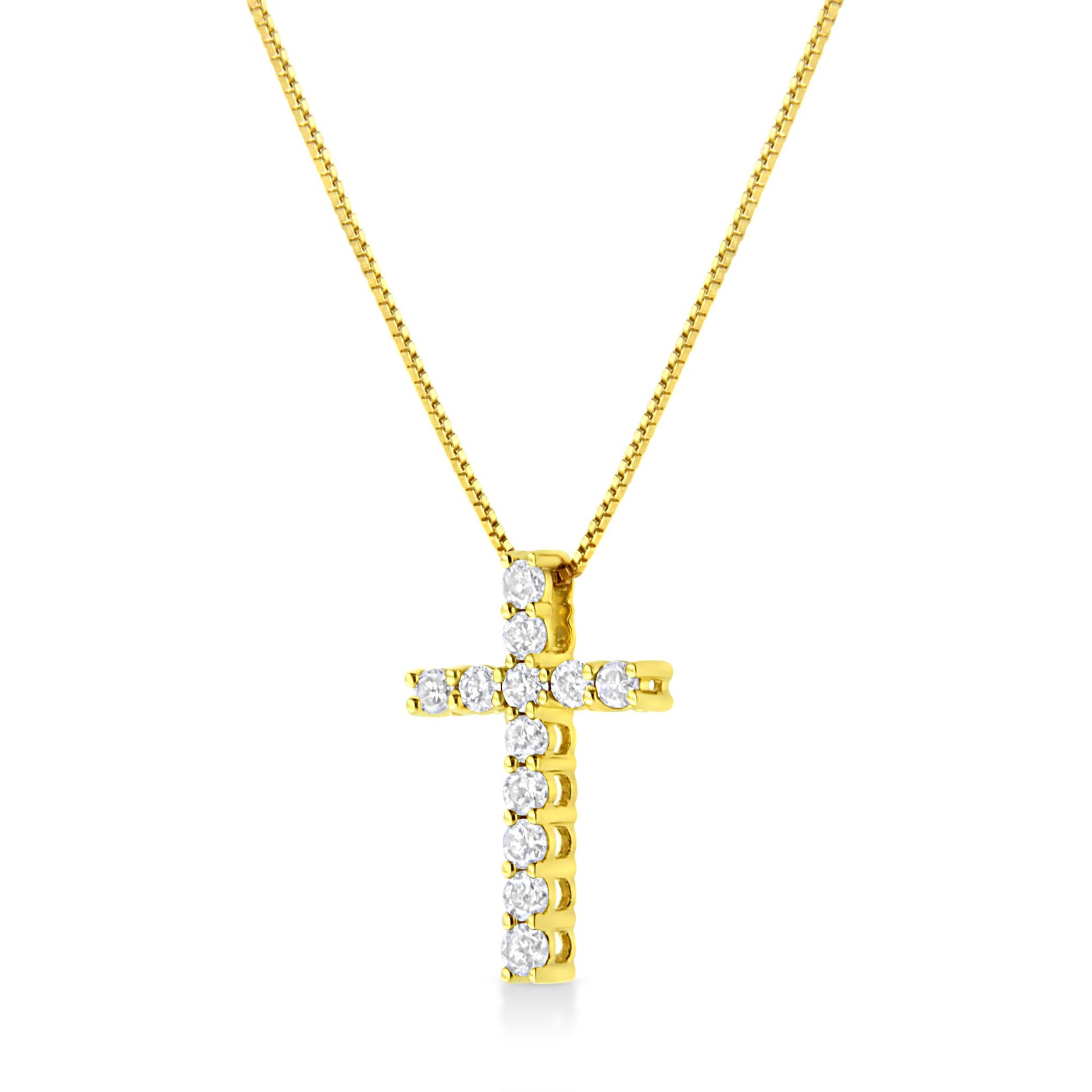 Front angle view of a yellow metal cross necklace with round white gemstones in prong settings.