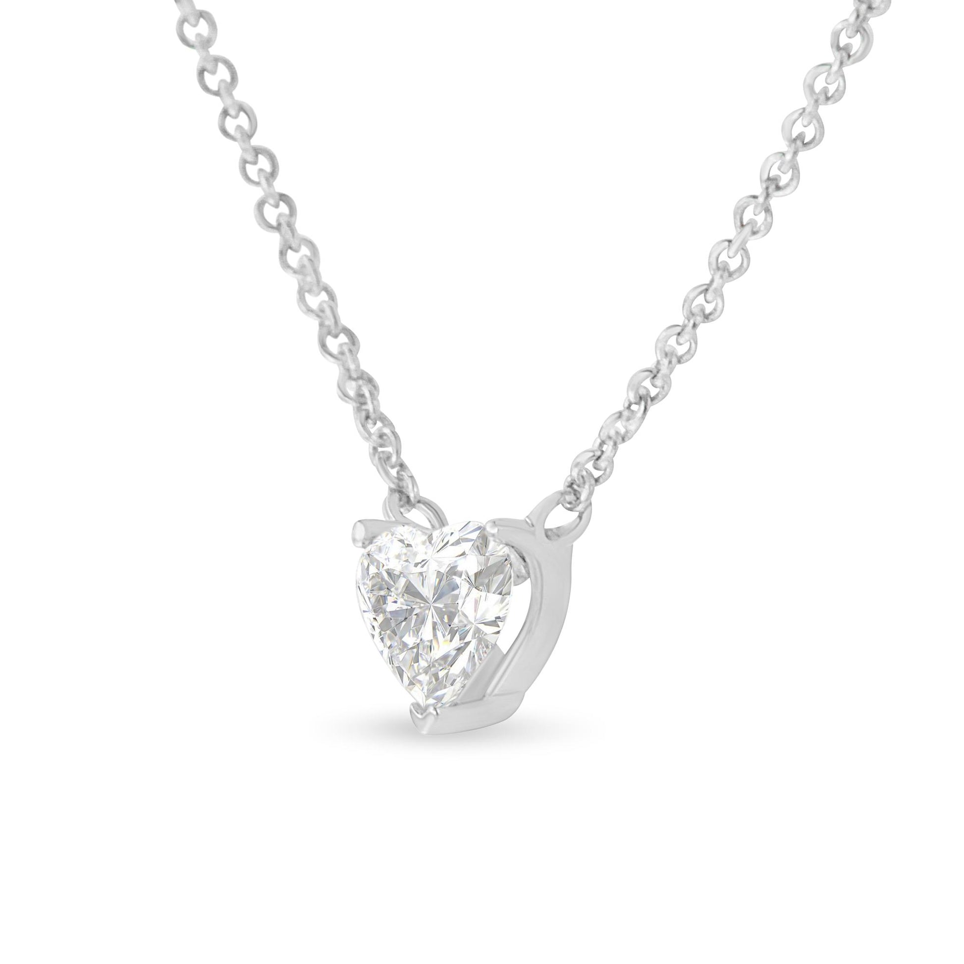 Front angle view of a white metal necklace with a heart-shaped white gemstone in a prong setting.