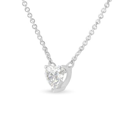 Front angle view of a white metal necklace with a heart-shaped white gemstone in a prong setting.