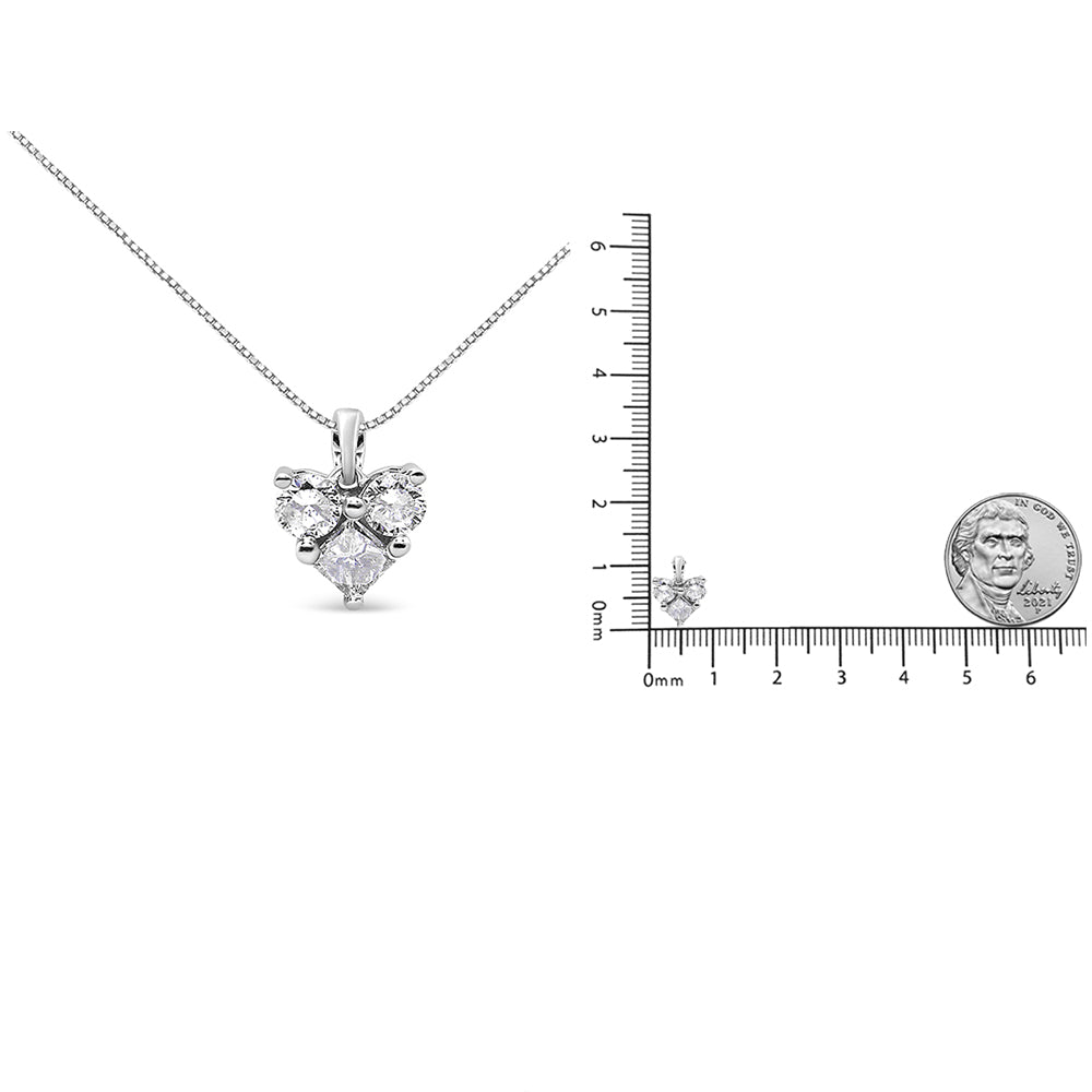 White metal necklace with a heart-shaped pendant featuring one princess shape white gemstone and two round shape white gemstones, displayed with a ruler and a coin for size reference, front view.