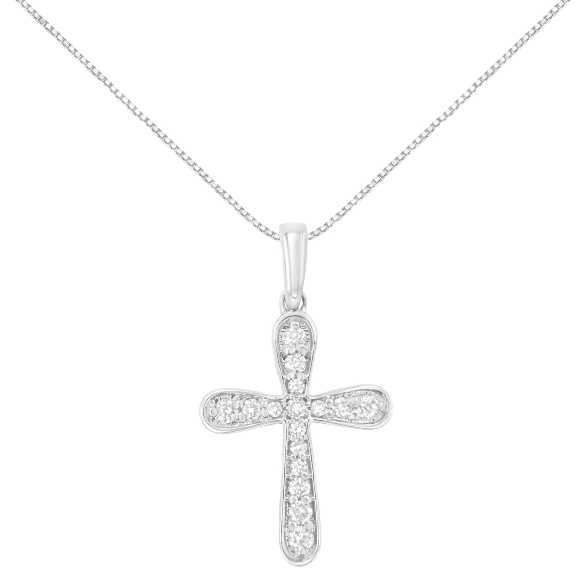 Front view of white metal cross-shaped necklace pendant adorned with multiple round white gemstones in prong settings on a thin chain.