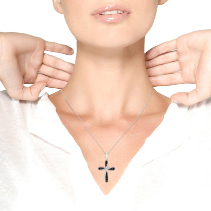 White metal necklace with a cross pendant featuring round white and black gemstones in prong settings, worn on a model, front-facing angle.
