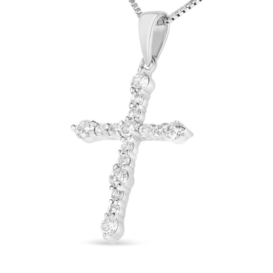 Close-up side angled view of a white metal cross-shaped necklace pendant with round white gemstones in prong settings, hanging from a box chain.