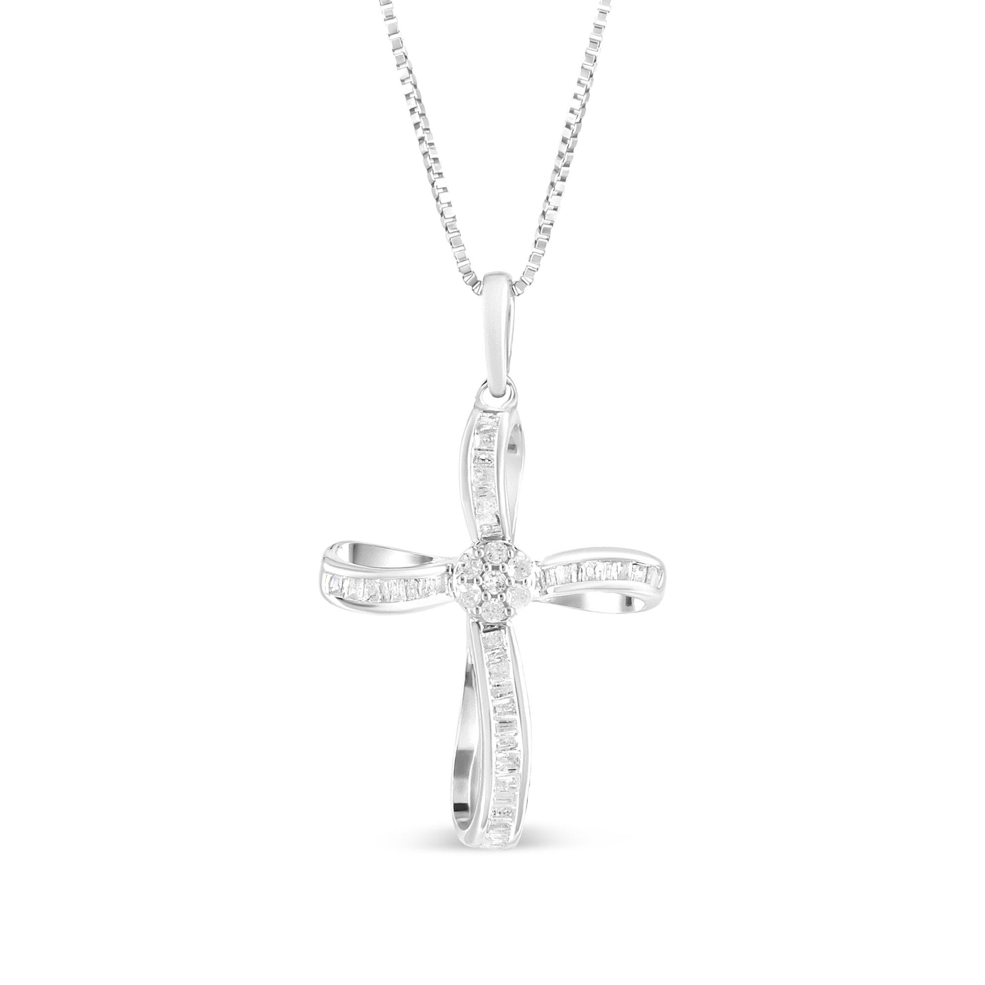 Front angle view of a white metal cross necklace pendant featuring round white gemstones in prong settings at the center and baguette white gemstones in channel settings along the arms, hanging from a white metal chain.