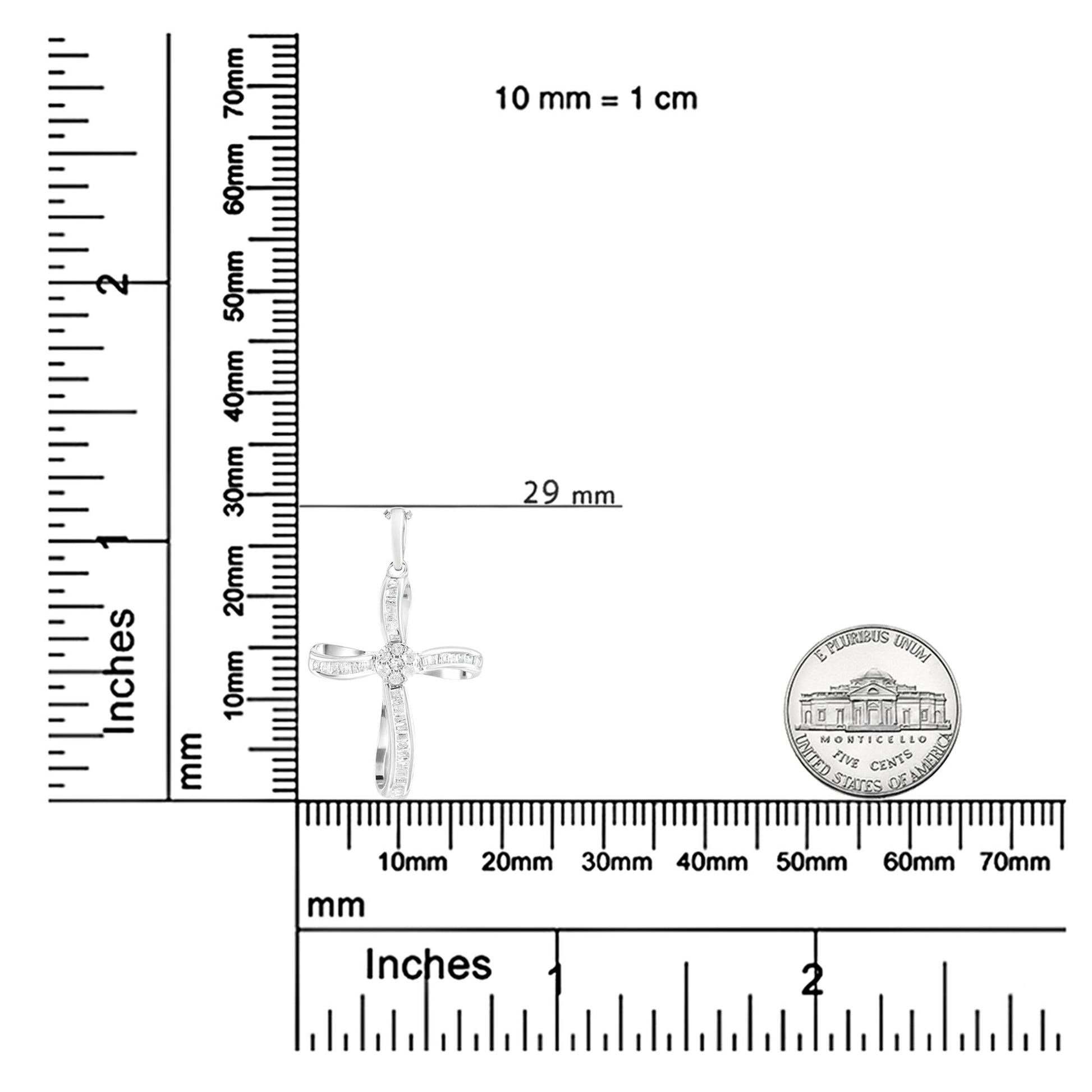 Pendant cross necklace with round and baguette white gemstones, shown on a ruler and scale for size reference, front angle.