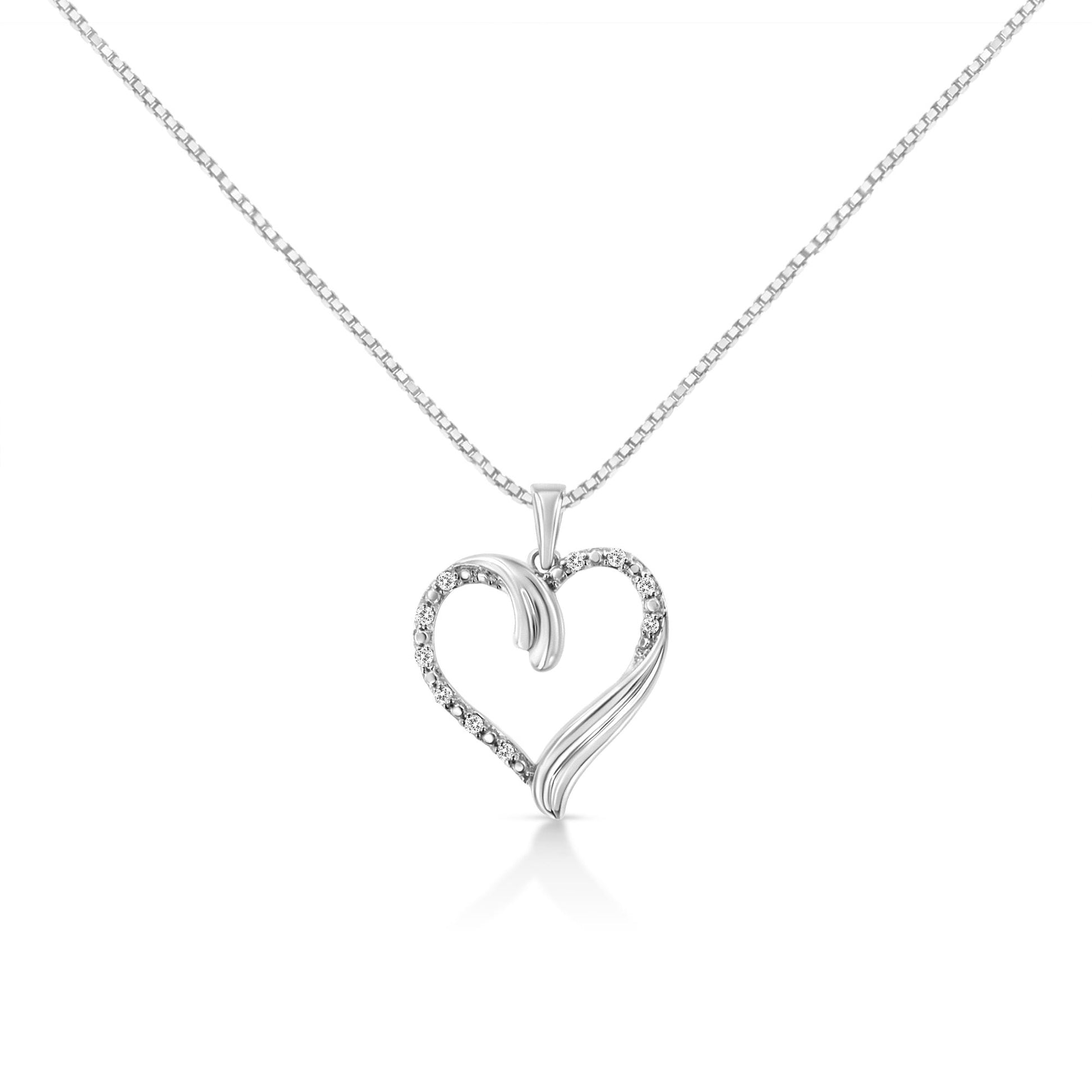 Front view of a white metal heart-shaped necklace pendant with round white gemstones set along one side, captured against a white background.