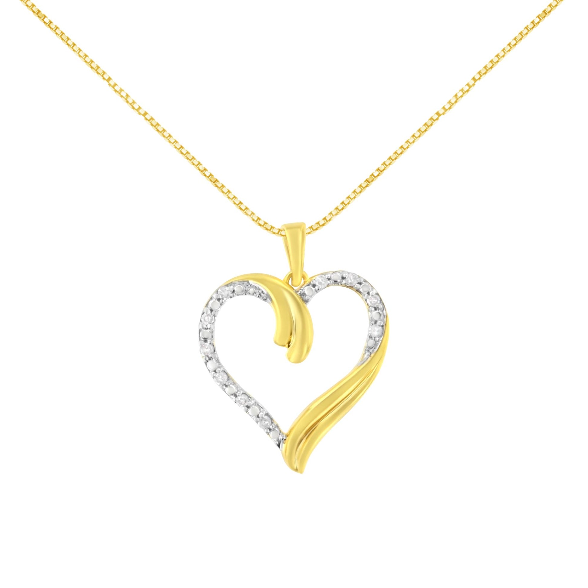 Front-facing shot of a yellow metal heart-shaped necklace pendant with round white gemstones along part of the heart outline, featuring a swirl design on the right and inside left of the heart.
