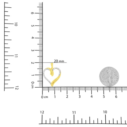 Yellow heart-shaped necklace pendant with white round gemstones in prong setting, shown on ruler and scale for size reference, front angle.