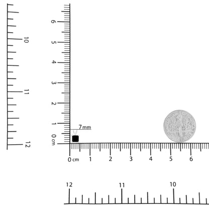 Close-up shot of a white necklace pendant featuring a princess-shaped black gemstone in a prong setting, placed on rulers and next to a dime for size reference.