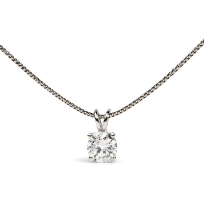 Close-up front view of a white metal necklace with a round white gemstone in a four-prong setting pendant.