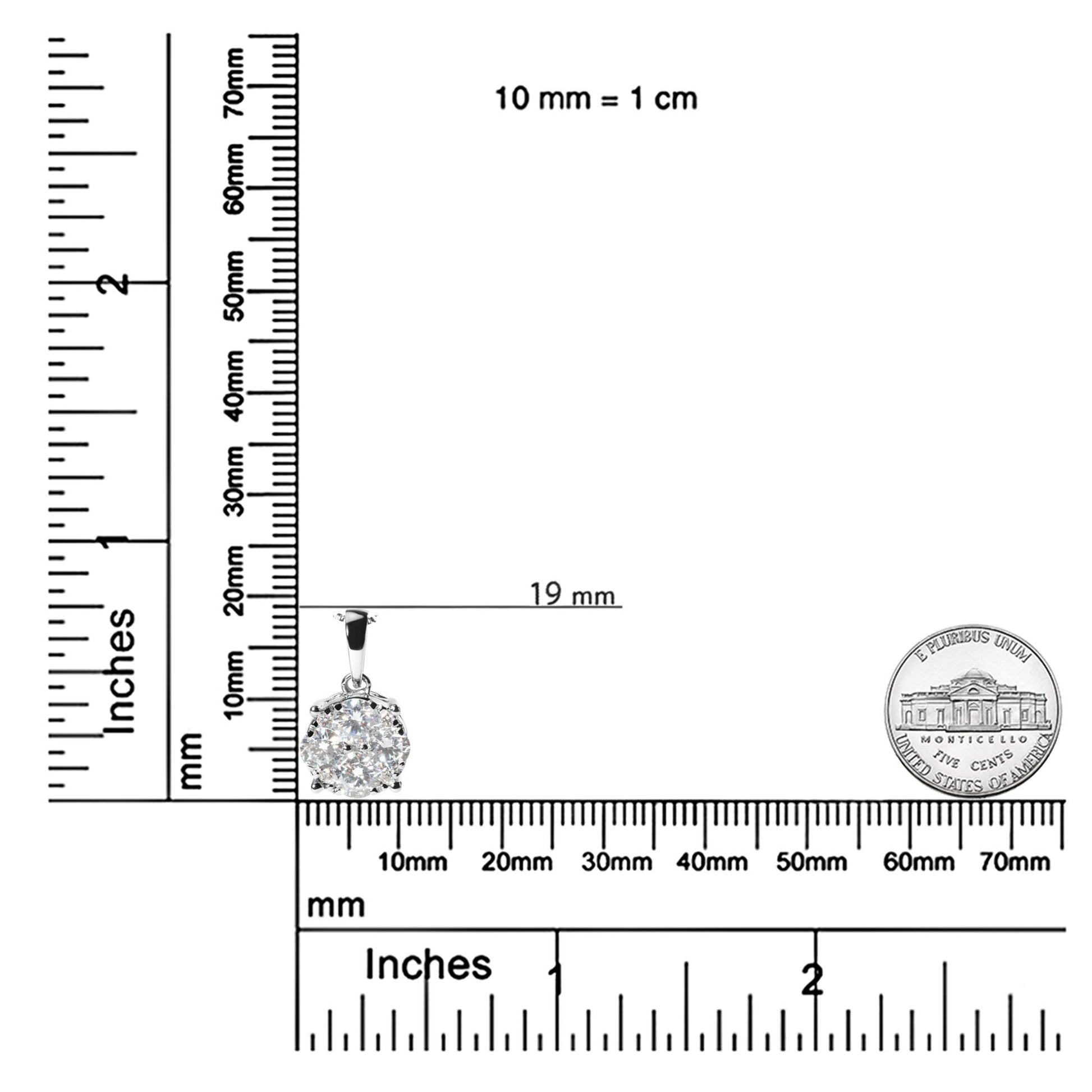White metal necklace pendant with round prong-set white gemstones arranged in a cluster, shown on a ruler and scale for size reference, top-front angle.
