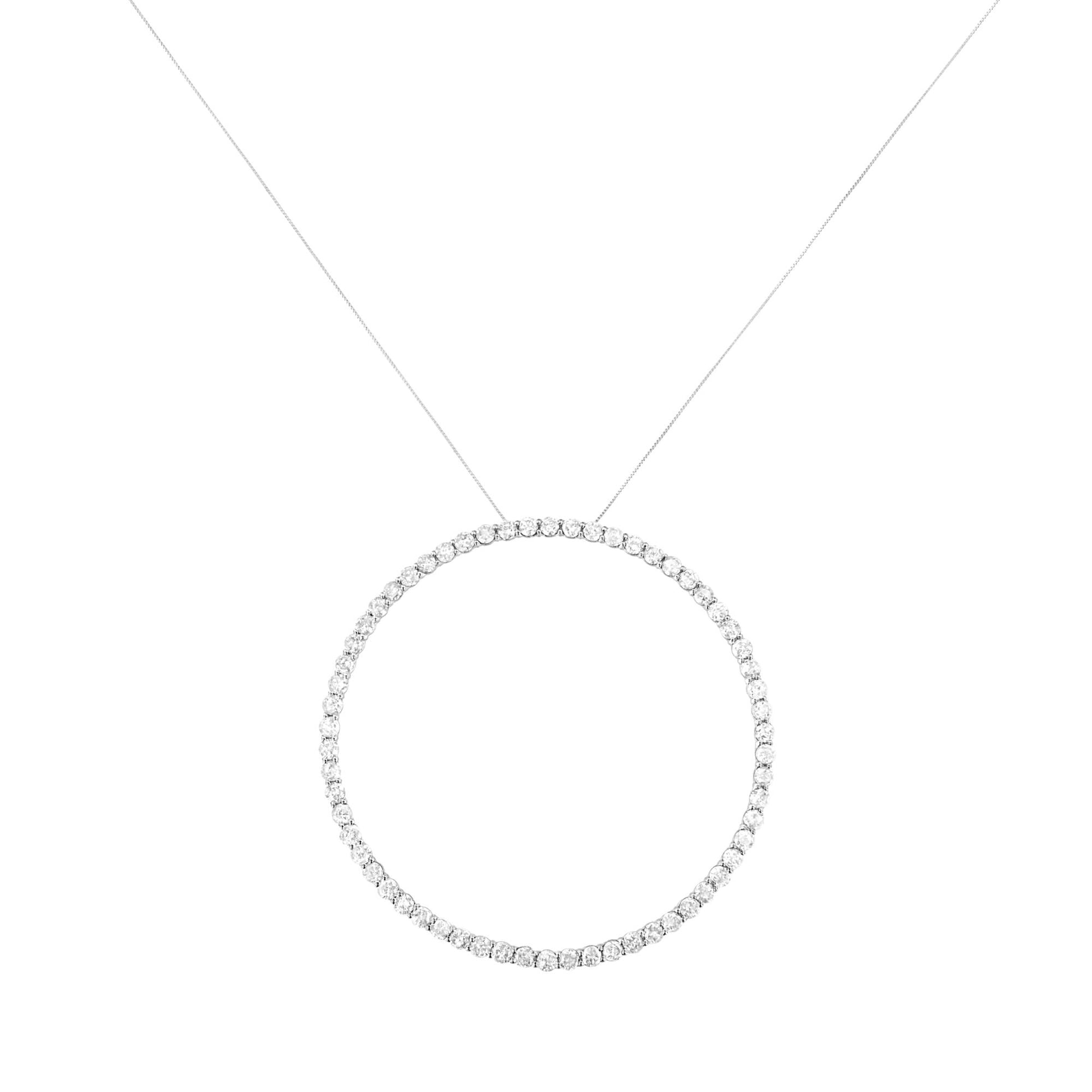 Front-facing shot of a white metal necklace featuring a circular pendant adorned with round white gemstones in prong settings.