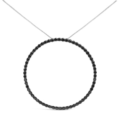 Front-facing view of a white metal necklace featuring a circular pendant with round black gemstones in a shared prong setting.