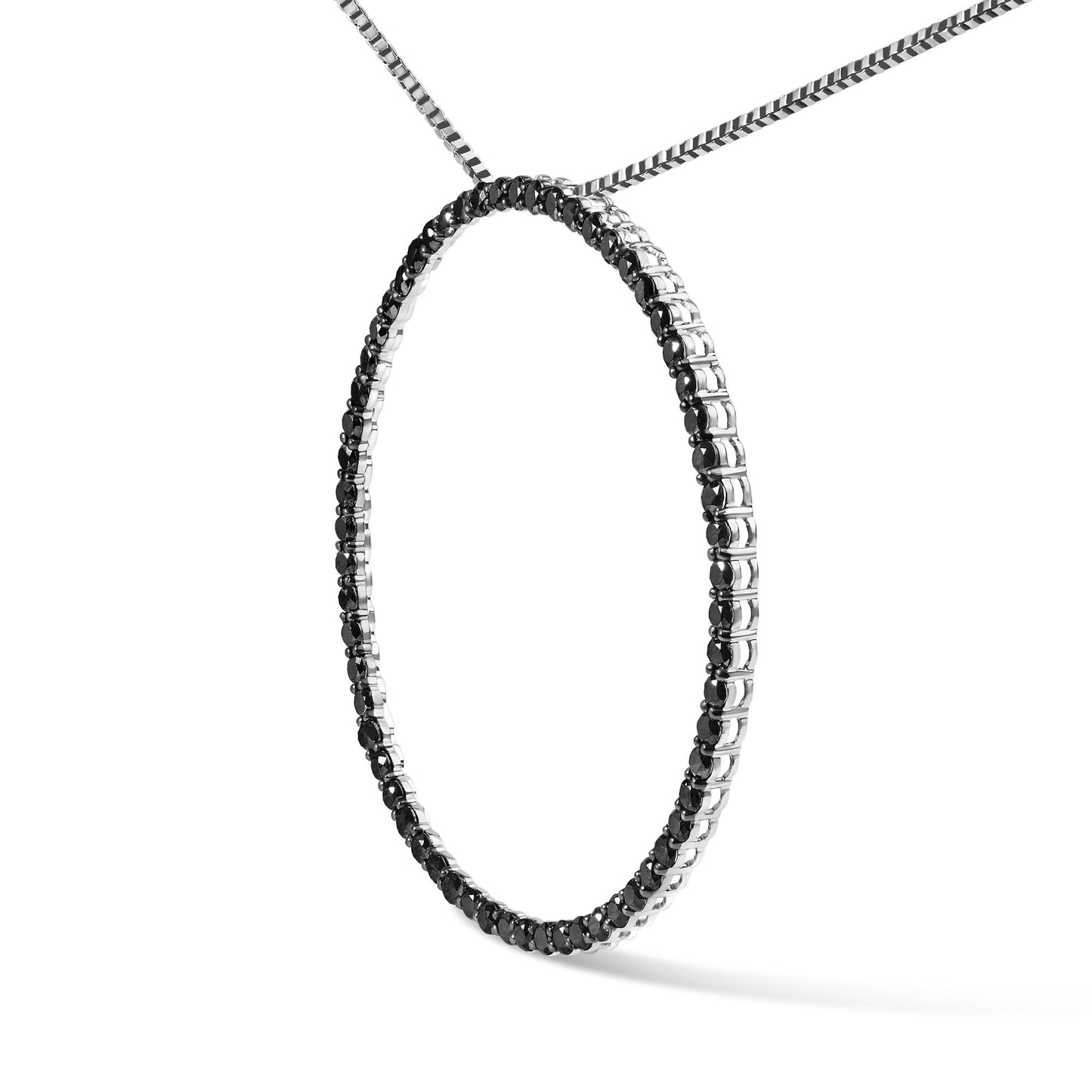 White metal necklace with a circular pendant featuring round black gemstones in a shared prong setting, shown in a close-up angled view.