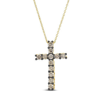Front-facing close-up of a yellow metal cross necklace with round champagne-colored gemstones in prong settings.