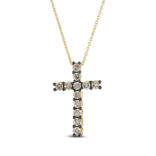 Front-facing close-up of a yellow metal cross necklace with round champagne-colored gemstones in prong settings.