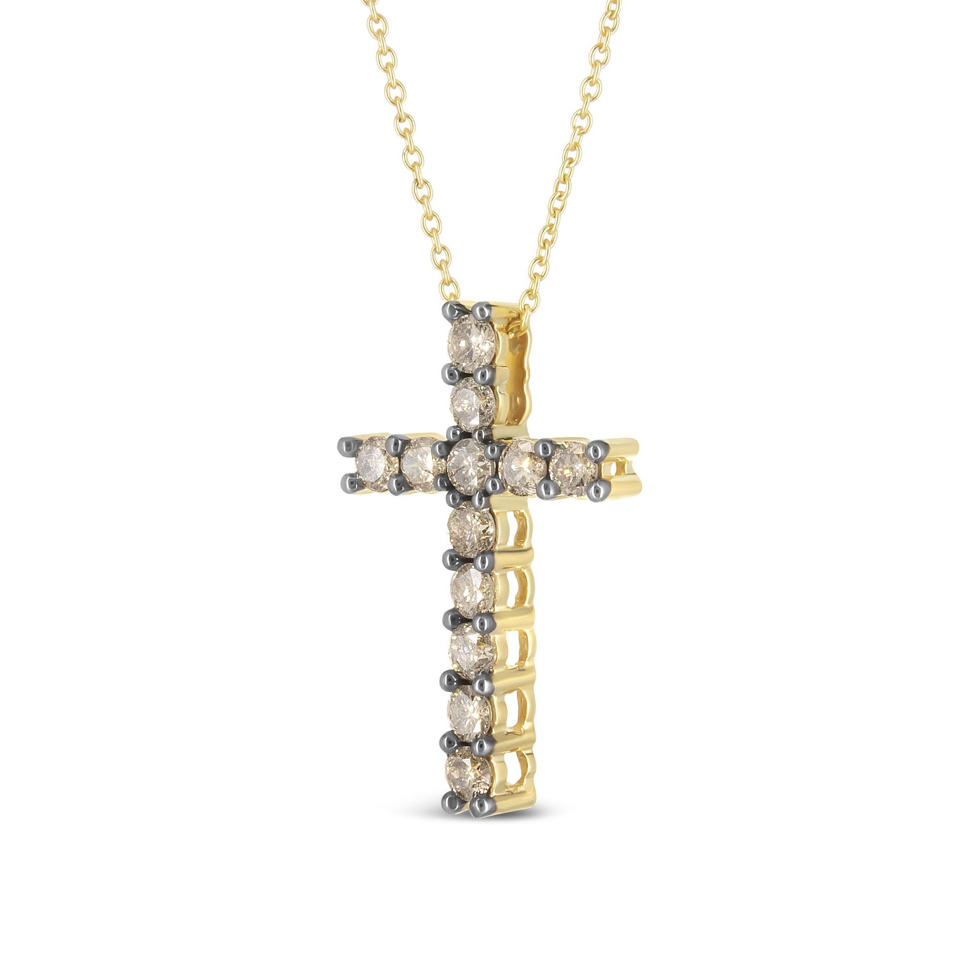 Front angled view of a yellow metal cross necklace pendant adorned with round prong-set champagne-colored gemstones.