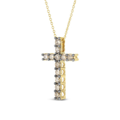 Front angled view of a yellow metal cross necklace pendant adorned with round prong-set champagne-colored gemstones.