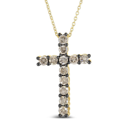 Front-facing shot of a yellow metal cross necklace with round champagne-colored gemstones in prong settings.