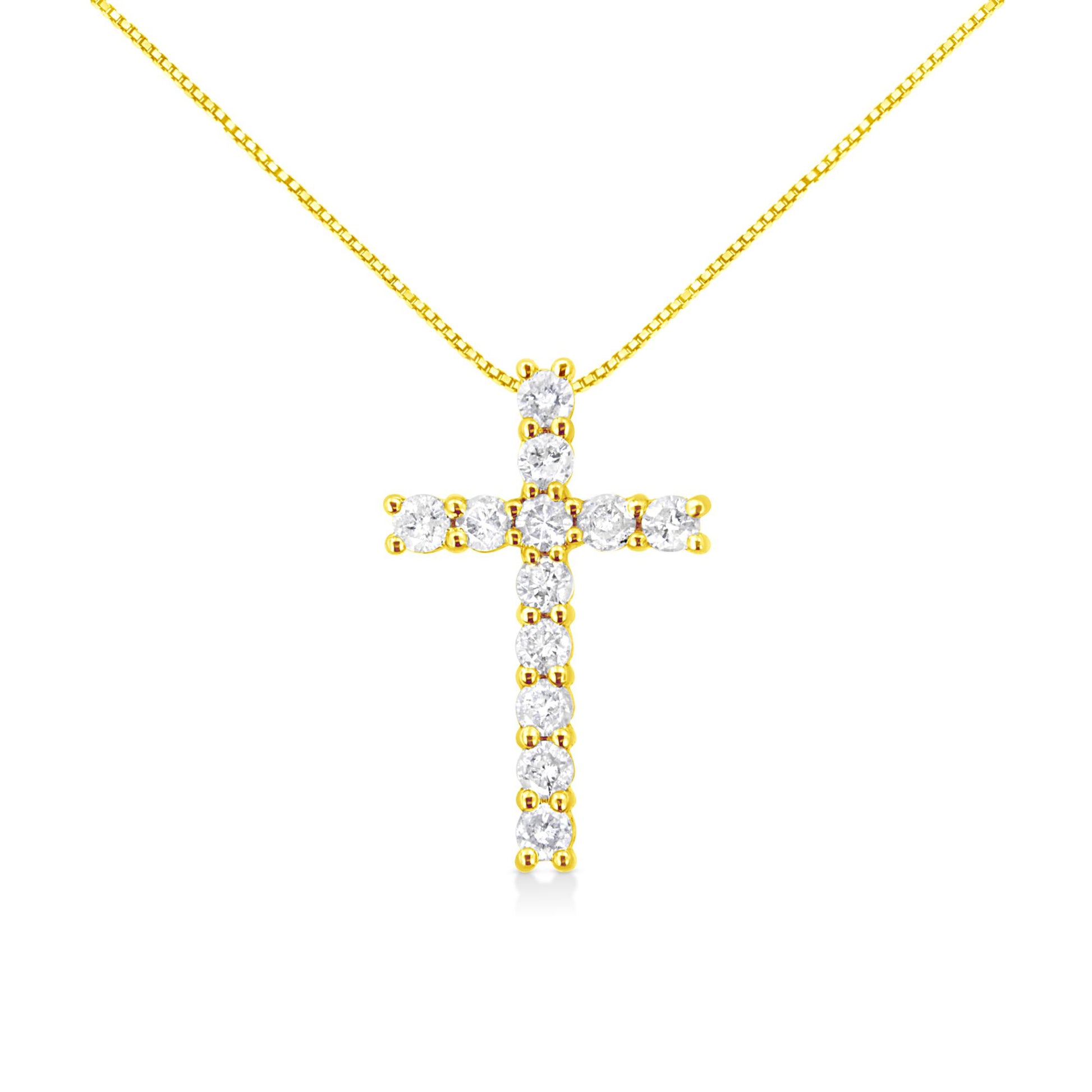 Front view of a yellow metal necklace with a cross pendant featuring round white gemstones in prong settings.