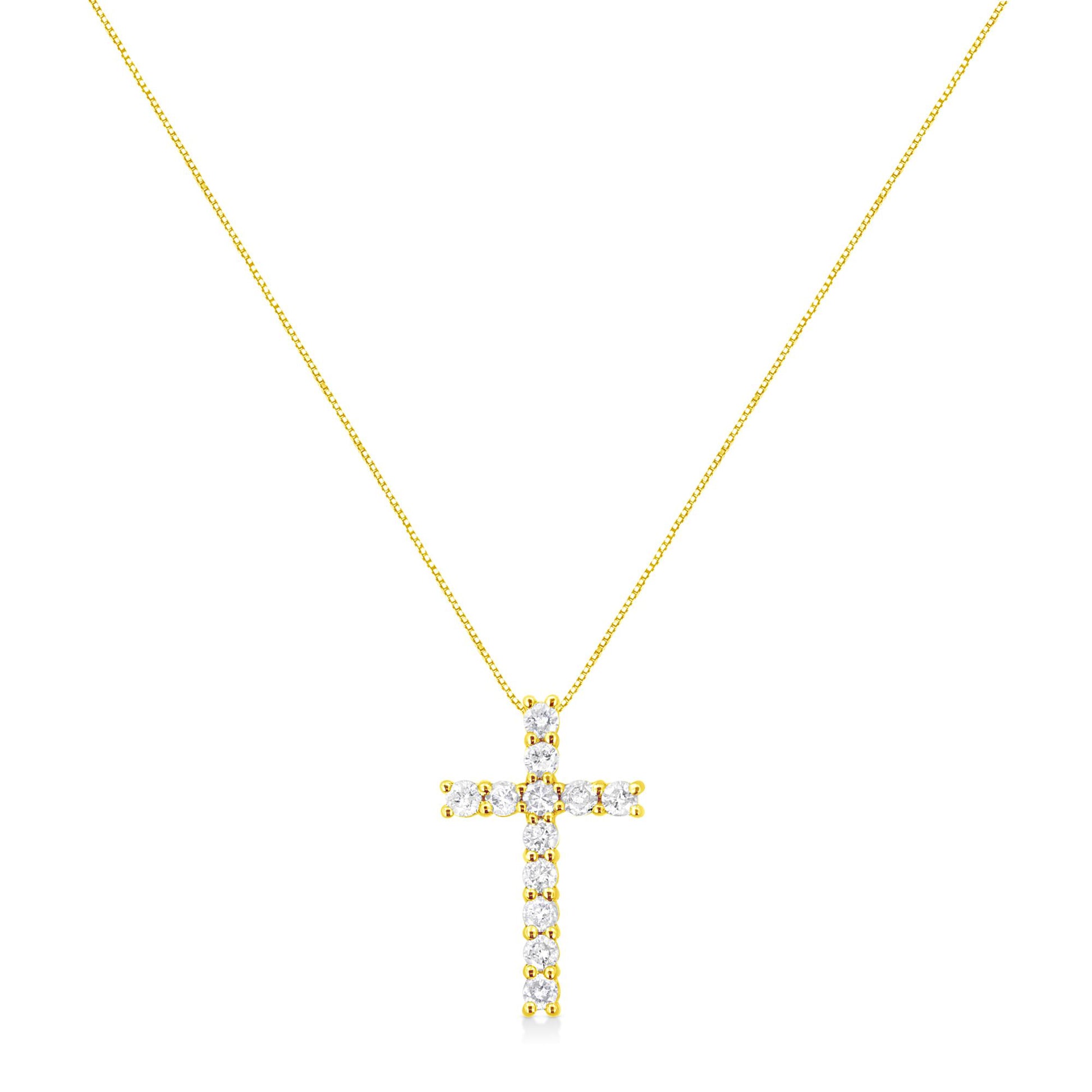 Front-facing view of a yellow metal cross-shaped necklace pendant with round prong-set white gemstones on a thin chain.