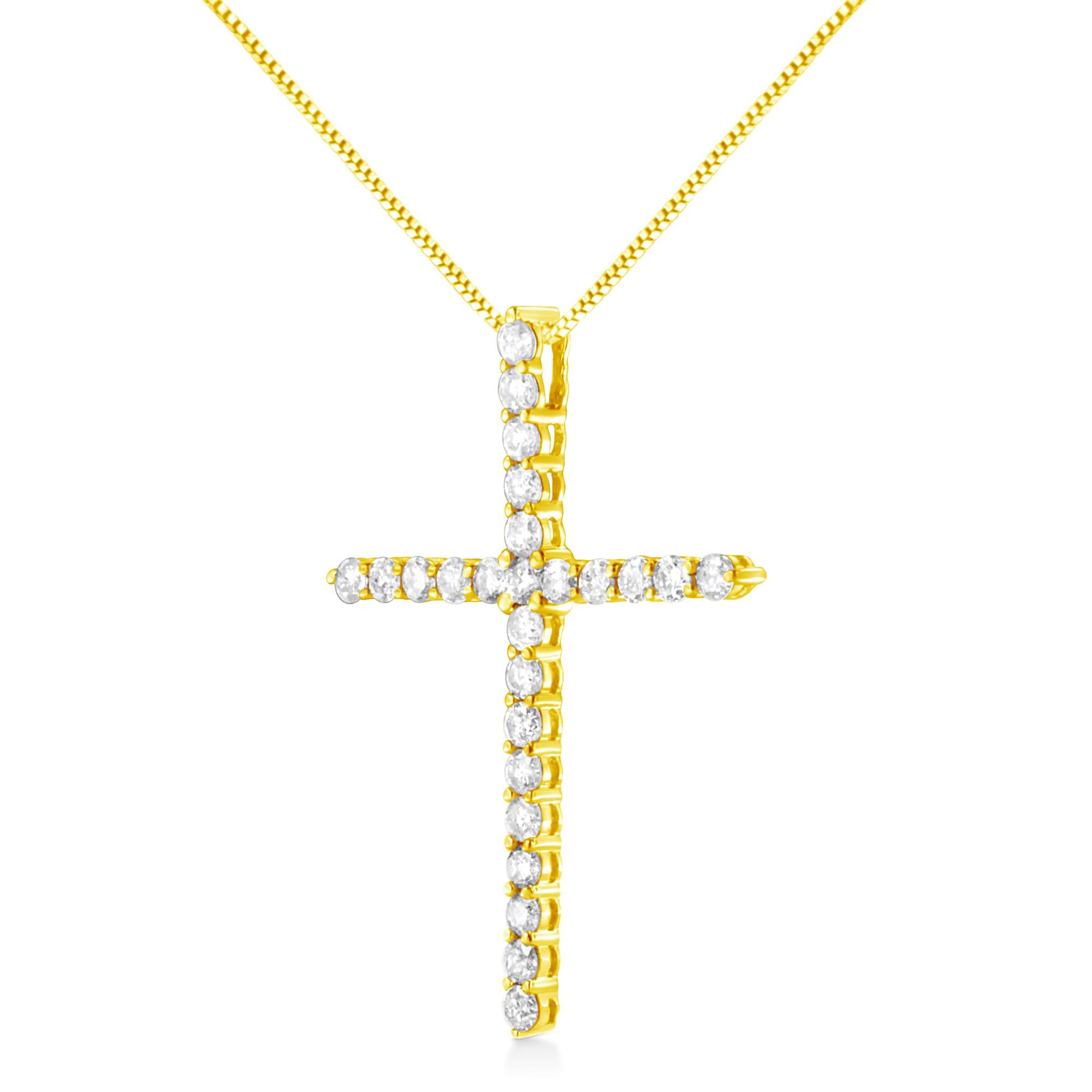 Front-facing close-up of yellow metal cross necklace with round white gemstones in prong settings.
