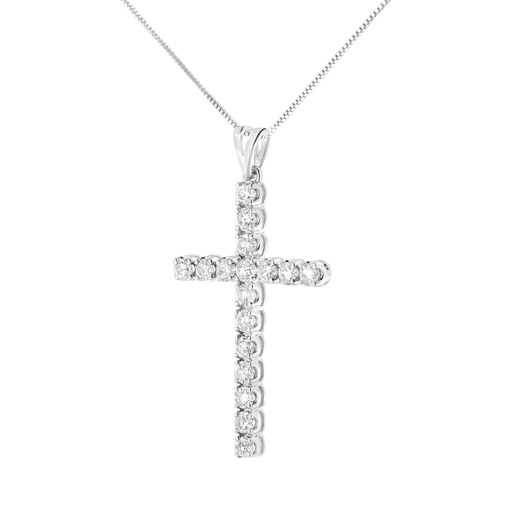 Front angle view of a white metal necklace with a cross pendant set with round white gemstones in prong settings.