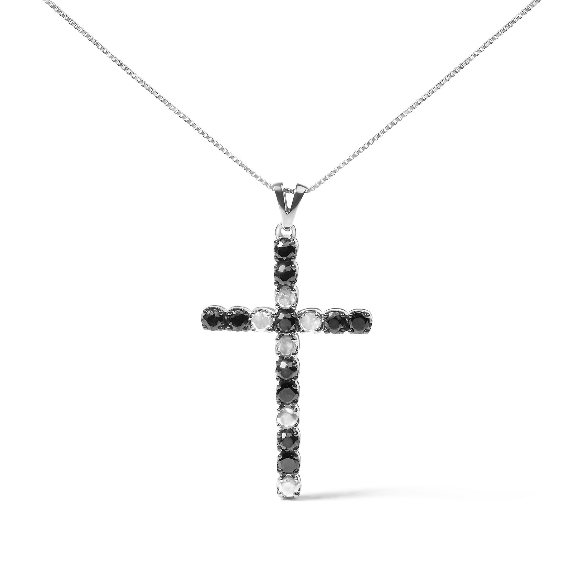 Front view of white metal necklace with cross pendant featuring round prong-set black and white gemstones.