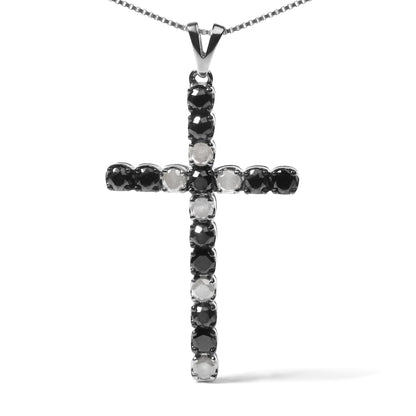 Front-facing shot of a white metal cross pendant necklace with alternating round black and white gemstones in prong settings.