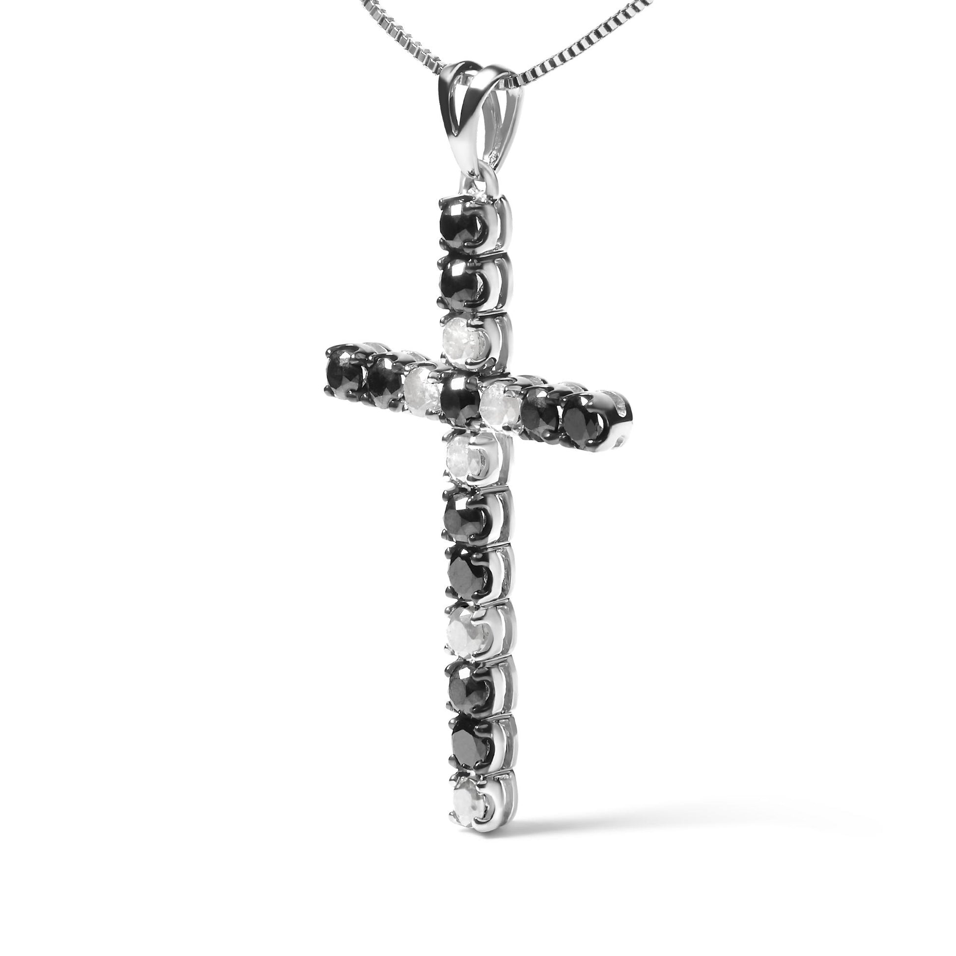 White metal cross-shaped necklace pendant with alternating round black and white gemstones in prong settings, shown in a close-up front angle.