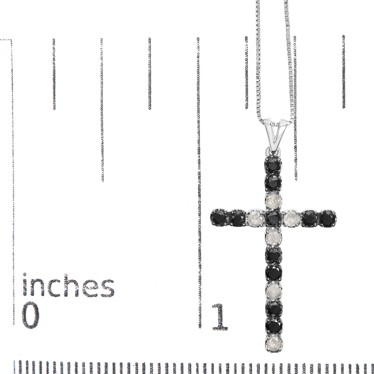 Close-up front view of a white metal cross pendant necklace with alternating black and white round prong-set gemstones, displayed on a ruler for size reference.