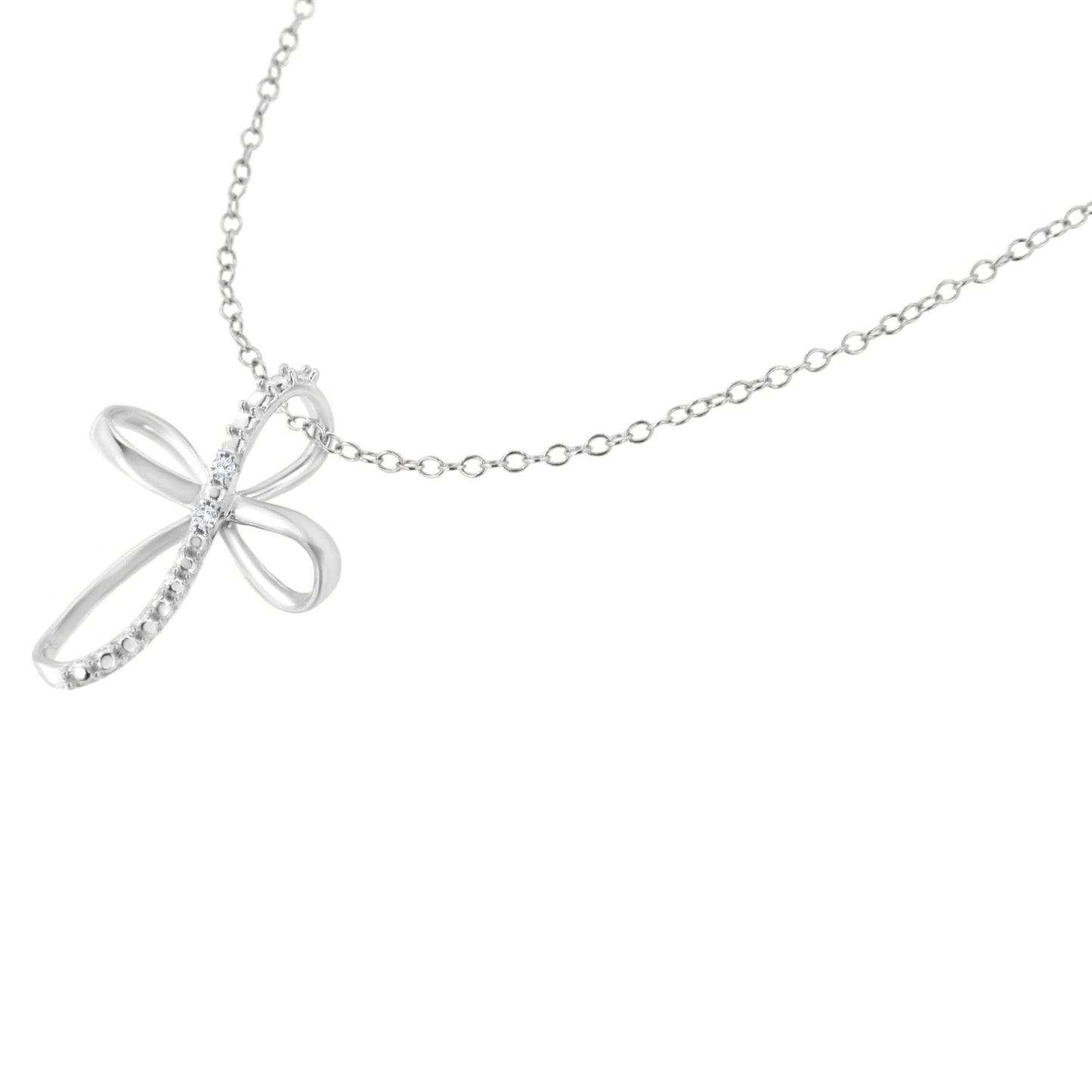 Close-up front angle of a white metal necklace with a pendant shaped like a stylized cross featuring two white round gemstones in prong settings.