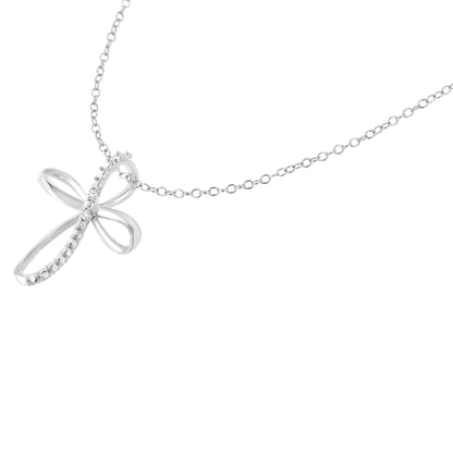 Close-up front angle of a white metal necklace with a pendant shaped like a stylized cross featuring two white round gemstones in prong settings.
