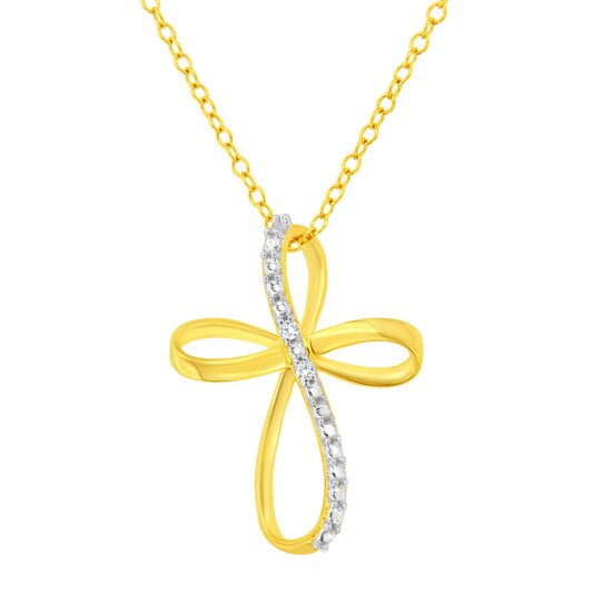 Front view of a yellow metal cross-shaped necklace pendant with a curved line of prong-set white round gemstones on one side, hanging from a matching yellow chain.