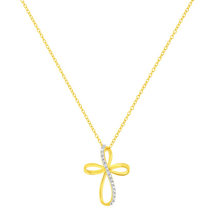 Front-facing view of yellow metal necklace with cross-shaped pendant featuring a curved line of white round gemstones in prong settings.