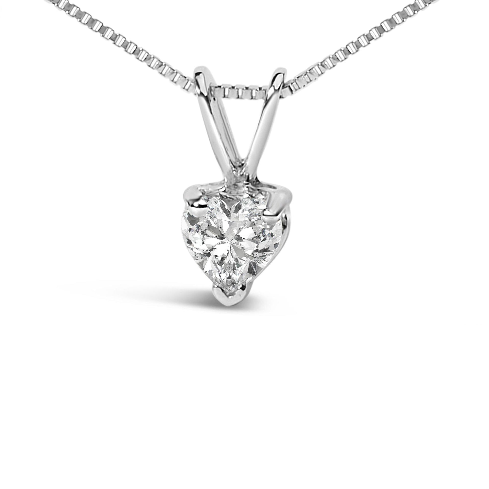 Close-up front view of a white metal necklace with a heart-shaped white gemstone pendant in a three-prong setting.